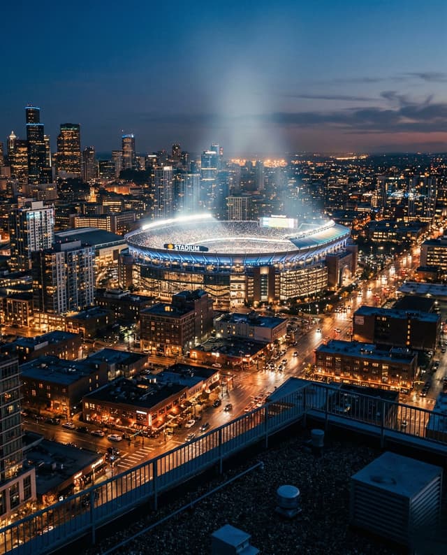 City skyline at dusk with stadium lights